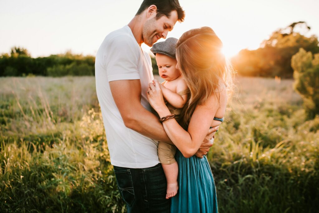 man and woman with baby